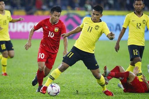 Malaysia (áo vàng) chưa thể hiện được lối chơi ổn định ở AFF Cup sau ba trận